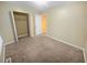 Bedroom with neutral carpeting, window, and mirrored closet doors at 1089 Brittwood Pl, Norcross, GA 30093