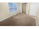 Bedroom with neutral carpeting, window, and mirrored closet doors at 1089 Brittwood Pl, Norcross, GA 30093