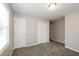 Well-lit bedroom with neutral carpeting and ample closet space at 1381 High Meadow Dr, Stone Mountain, GA 30083