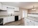 Updated kitchen featuring white cabinets, granite countertops, and stainless steel appliances at 1381 High Meadow Dr, Stone Mountain, GA 30083