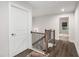 Hallway with wood floors, black railings, and white doors leading to other rooms at 1391 Harris Way, Brookhaven, GA 30319