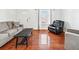 Comfortable living room with hardwood floors, sofa, and an accent chair at 1625 Conley Rd # 270, Conley, GA 30288