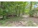 Beautiful wooded backyard with the back deck in the background, a great space for nature lovers at 4259 Arbor Club Dr, Marietta, GA 30066