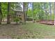 Backyard landscape showing a deck, stairs, mature trees, and lawn area at 4259 Arbor Club Dr, Marietta, GA 30066