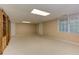 This finished basement has neutral walls, carpeted flooring, and natural light at 4259 Arbor Club Dr, Marietta, GA 30066