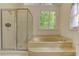 Bright bathroom featuring a soaking tub, shower, and large windows at 4259 Arbor Club Dr, Marietta, GA 30066