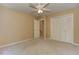 This bedroom includes neutral walls, a closet, a ceiling fan and plush carpeting at 4259 Arbor Club Dr, Marietta, GA 30066
