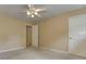 This bedroom features neutral walls, a ceiling fan with lights, and plush carpeting at 4259 Arbor Club Dr, Marietta, GA 30066