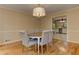 Formal dining room featuring hardwood floors, a pendant chandelier, and neutral decor, and a view into the kitchen at 4259 Arbor Club Dr, Marietta, GA 30066