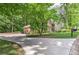 Long driveway leading to a charming brick two-story home with verdant landscaping and an attached two-car garage at 4259 Arbor Club Dr, Marietta, GA 30066