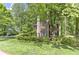 Charming brick two-story home nestled among mature trees, offering verdant landscaping and a serene wooded backdrop at 4259 Arbor Club Dr, Marietta, GA 30066