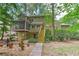 Rear exterior showcasing a spacious deck and screened porch overlooking the backyard's lush greenery at 4259 Arbor Club Dr, Marietta, GA 30066