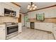 Well-appointed kitchen featuring stainless steel appliances, white cabinets, and granite countertops with ample storage space at 4259 Arbor Club Dr, Marietta, GA 30066