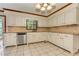 Bright kitchen with white cabinets, granite counters, stainless steel appliances, and tile floors at 4259 Arbor Club Dr, Marietta, GA 30066