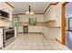 Bright kitchen with tile floor, white cabinets, granite counters, and stainless steel appliances at 4259 Arbor Club Dr, Marietta, GA 30066