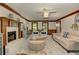 Open concept living room featuring a brick fireplace, comfortable seating, and natural light from the windows at 4259 Arbor Club Dr, Marietta, GA 30066