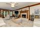 Inviting living room featuring a brick fireplace, comfortable seating, a ceiling fan, and views to the backyard at 4259 Arbor Club Dr, Marietta, GA 30066