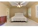 Spacious main bedroom with plush carpeting, a tray ceiling, and a ceiling fan at 4259 Arbor Club Dr, Marietta, GA 30066