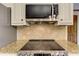 Stainless steel oven with granite counter tops and decorative tile backsplash at 4259 Arbor Club Dr, Marietta, GA 30066