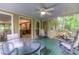 Inviting screened porch with ceiling fan, comfortable seating, and view to the interior living area at 4259 Arbor Club Dr, Marietta, GA 30066