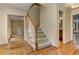 Carpeted staircase with wood railing and hardwood floors at 4259 Arbor Club Dr, Marietta, GA 30066