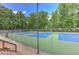 Community tennis court with lush greenery all around, perfect for a relaxing game outdoors at 4259 Arbor Club Dr, Marietta, GA 30066