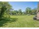 Well-maintained backyard featuring a large lawn, mature trees, and a brick house at 3710 Lynn Dr # A & B, Powder Springs, GA 30127