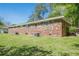 Spacious backyard features a brick house with a well-maintained lawn and mature trees at 3710 Lynn Dr # A & B, Powder Springs, GA 30127