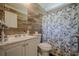 Neutral bathroom features a shower with a floral curtain, wood-look tile, and vanity at 3710 Lynn Dr # A & B, Powder Springs, GA 30127
