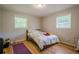 Simple bedroom with hardwood floors, two windows, and ample natural light at 3710 Lynn Dr # A & B, Powder Springs, GA 30127