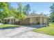 Side view of a brick home with a covered parking area and grassy yard at 3710 Lynn Dr # A & B, Powder Springs, GA 30127