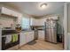 Well-equipped kitchen with stainless steel appliances, white cabinets, and laminate countertops at 3710 Lynn Dr # A & B, Powder Springs, GA 30127