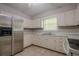 Functional kitchen with stainless steel refrigerator, ample counter space, and tile floors at 3710 Lynn Dr # A & B, Powder Springs, GA 30127