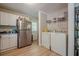 Combined kitchen/laundry area with stainless steel refrigerator and white appliances at 3710 Lynn Dr # A & B, Powder Springs, GA 30127