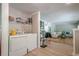 Functional laundry area with a washing machine, dryer, shelving, and view of the living room at 3710 Lynn Dr # A & B, Powder Springs, GA 30127