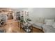 Open-concept living room with hardwood floors, a large couch, and view of the kitchen and workspace at 3710 Lynn Dr # A & B, Powder Springs, GA 30127