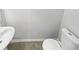 Simple bathroom with white toilet and sink at 7085 Magnolia Ln, Fairburn, GA 30213