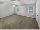 Large bedroom with neutral carpeting and ceiling fan at 7085 Magnolia Ln, Fairburn, GA 30213