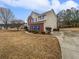 Two-story house with brick and siding, blue shutters, and a landscaped lawn at 7085 Magnolia Ln, Fairburn, GA 30213
