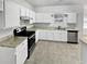 Modern kitchen with white cabinets, granite countertops, and stainless steel appliances at 7085 Magnolia Ln, Fairburn, GA 30213