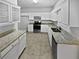 Kitchen features granite countertops and white cabinets at 7085 Magnolia Ln, Fairburn, GA 30213