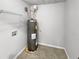 Laundry room with water heater and shelving at 7085 Magnolia Ln, Fairburn, GA 30213