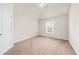 Spacious carpeted bedroom with large window at 175 Regency Pl, Covington, GA 30016