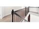 Modern staircase with black metal railing and carpet at 175 Regency Pl, Covington, GA 30016