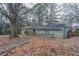 View of home's backyard with leaves on the ground at 180 Sears Cir, Covington, GA 30016