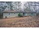 Spacious backyard with view of home and surrounding foliage at 180 Sears Cir, Covington, GA 30016