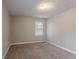 Bright bedroom featuring neutral walls, carpet, and a large window to let in natural light at 180 Sears Cir, Covington, GA 30016