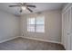 Cozy bedroom with a ceiling fan, large window, and closet provides a comfortable retreat at 180 Sears Cir, Covington, GA 30016