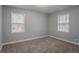 A bright bedroom with neutral walls and flooring offers a serene and comfortable space at 180 Sears Cir, Covington, GA 30016