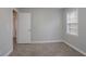 Bedroom featuring neutral walls, carpet flooring, and a window offers a cozy space at 180 Sears Cir, Covington, GA 30016
